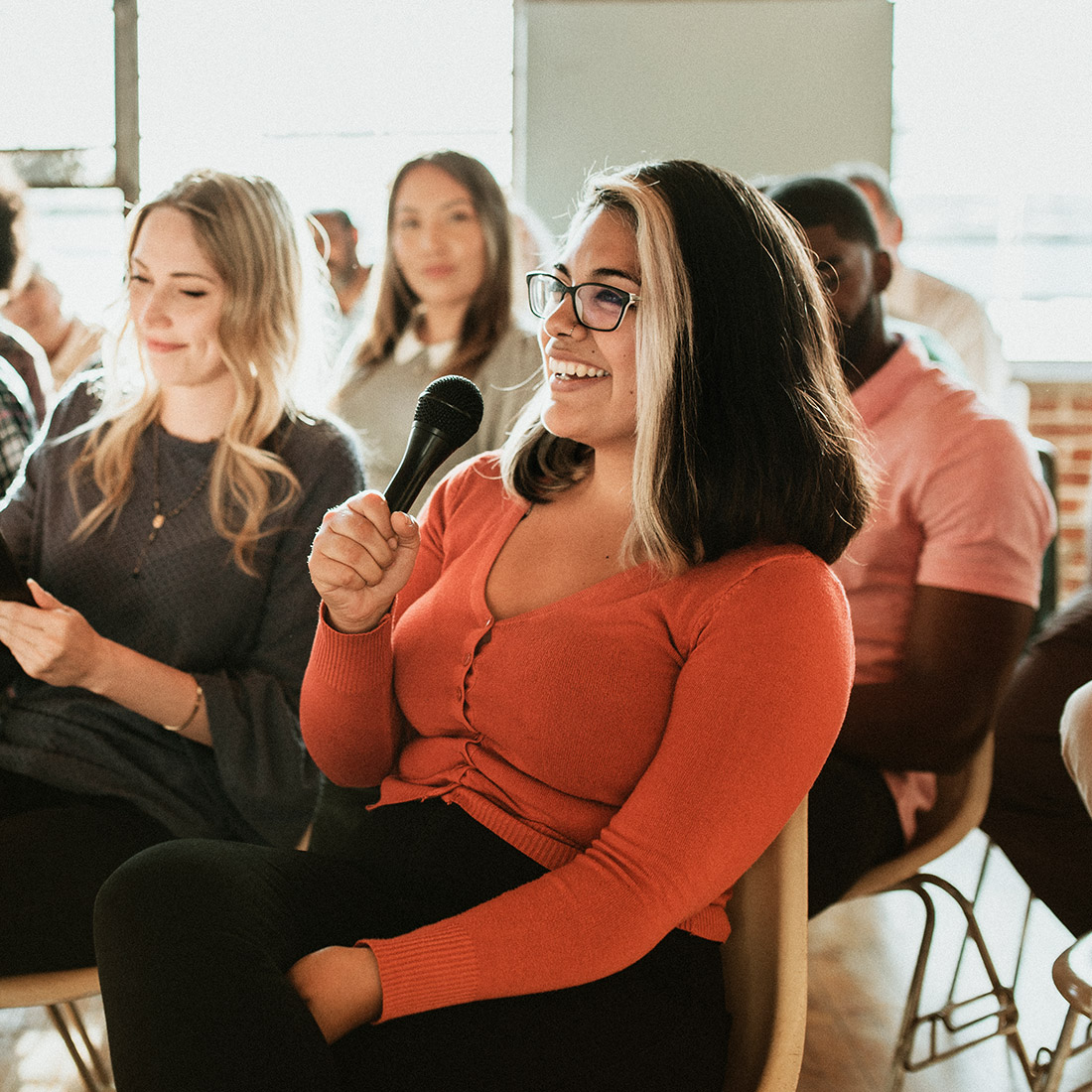 Woman asking a question at a conference